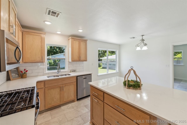 201 W 9th St, Claremore, OK 74017 - kitchen featuring appliances with stainless steel finishes, a sink, tasteful backsplash, healthy amount of natural light, and recessed lighting