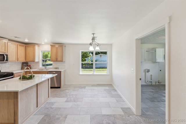 201 W 9th St, Claremore, OK 74017 - kitchen featuring stainless steel appliances, light countertops, backsplash, a sink, and recessed lighting