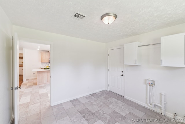 201 W 9th St, Claremore, OK 74017 - unfurnished room featuring a textured ceiling and baseboards