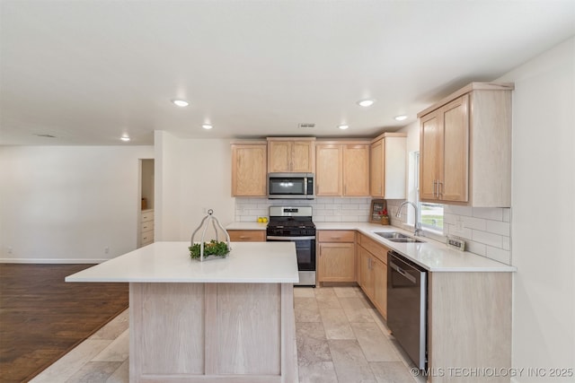 201 W 9th St, Claremore, OK 74017 - kitchen with stainless steel appliances, light brown cabinetry, a sink, light countertops, and recessed lighting