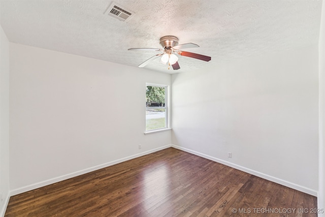 201 W 9th St, Claremore, OK 74017 - spare room with baseboards, dark wood-style flooring, and a textured ceiling