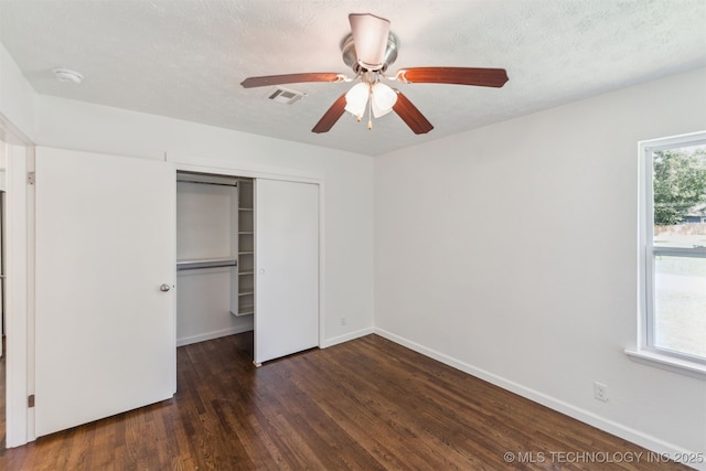 201 W 9th St, Claremore, OK 74017 - unfurnished bedroom with a closet, wood finished floors, baseboards, and ceiling fan