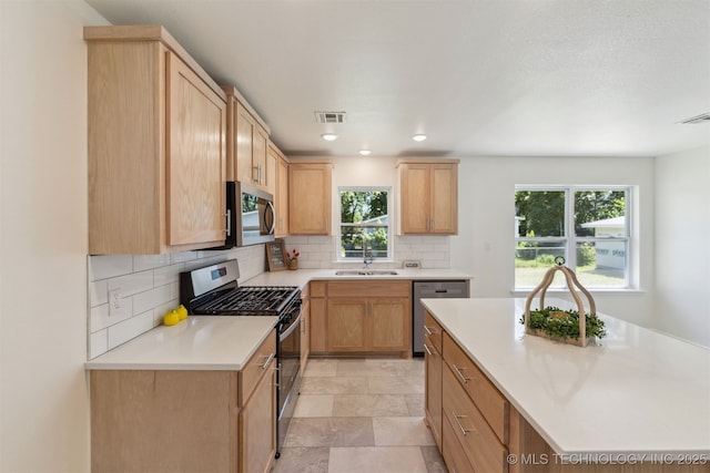 201 W 9th St, Claremore, OK 74017 - kitchen with stainless steel appliances, light brown cabinets, decorative backsplash, and recessed lighting