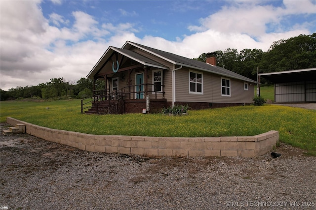 1965 Mcalester Lk, Mcalester, OK 74501 - view of side of property featuring a chimney, a porch, a lawn, and a carport