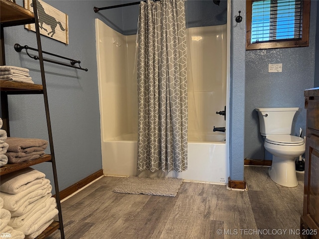 1965 Mcalester Lk, Mcalester, OK 74501 - full bathroom featuring wood finished floors, shower / tub combo with curtain, baseboards, toilet, and a textured wall