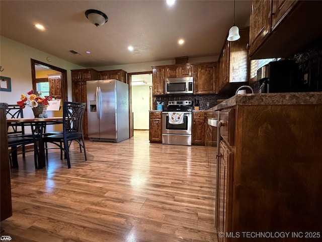 1965 Mcalester Lk, Mcalester, OK 74501 - kitchen with appliances with stainless steel finishes, light wood-style flooring, tasteful backsplash, recessed lighting, and a sink