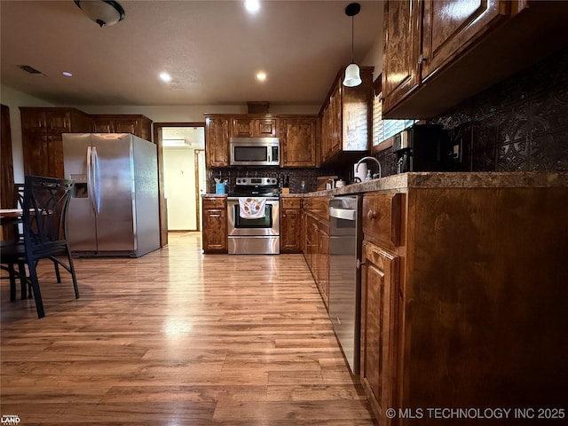 1965 Mcalester Lk, Mcalester, OK 74501 - kitchen with stainless steel appliances, light wood-style floors, tasteful backsplash, and recessed lighting