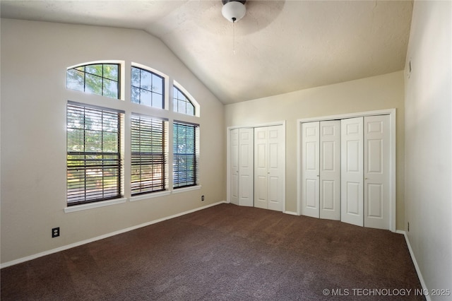 10511 S 83rd Cir, Tulsa, OK 74133 - unfurnished bedroom with multiple closets, vaulted ceiling, dark carpet, baseboards, and ceiling fan