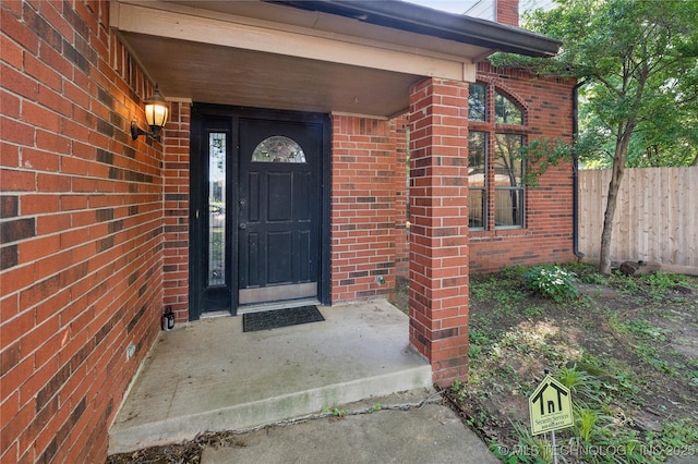 10511 S 83rd Cir, Tulsa, OK 74133 - doorway to property featuring brick siding and a chimney
