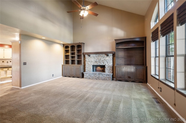 10511 S 83rd Cir, Tulsa, OK 74133 - unfurnished living room featuring high vaulted ceiling, carpet, ceiling fan, a fireplace, and baseboards