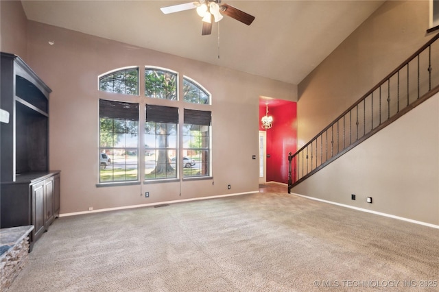 10511 S 83rd Cir, Tulsa, OK 74133 - unfurnished living room featuring ceiling fan, high vaulted ceiling, carpet floors, stairway, and baseboards
