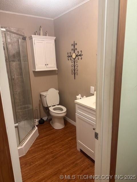 804 W Taliaferro, Madill, OK 73446 - full bathroom featuring vanity, toilet, a shower stall, wood finished floors, and a textured ceiling