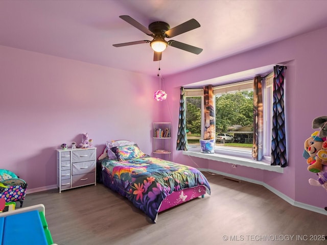 2318 Dorchester Dr, Bartlesville, OK 74006 - bedroom featuring wood finished floors, baseboards, and ceiling fan