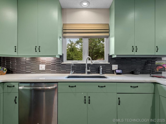 2318 Dorchester Dr, Bartlesville, OK 74006 - kitchen featuring stainless steel dishwasher, green cabinetry, a sink, backsplash, and a textured ceiling