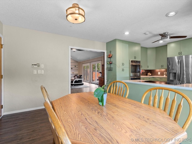2318 Dorchester Dr, Bartlesville, OK 74006 - dining area featuring french doors, ceiling fan, dark wood-style flooring, baseboards, and a textured ceiling