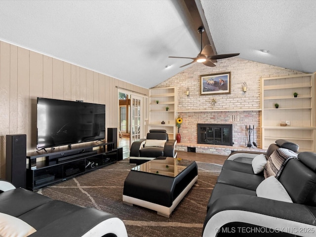 2318 Dorchester Dr, Bartlesville, OK 74006 - living area with a ceiling fan, a textured ceiling, wood walls, and a brick fireplace