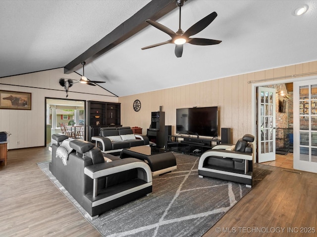 2318 Dorchester Dr, Bartlesville, OK 74006 - living area featuring a ceiling fan, wood finished floors, french doors, and wood walls