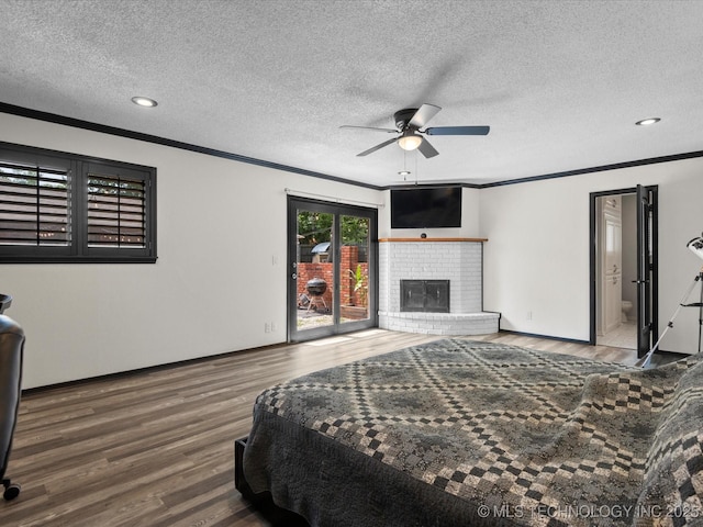 2318 Dorchester Dr, Bartlesville, OK 74006 - bedroom with ornamental molding, wood finished floors, access to exterior, a textured ceiling, and a fireplace