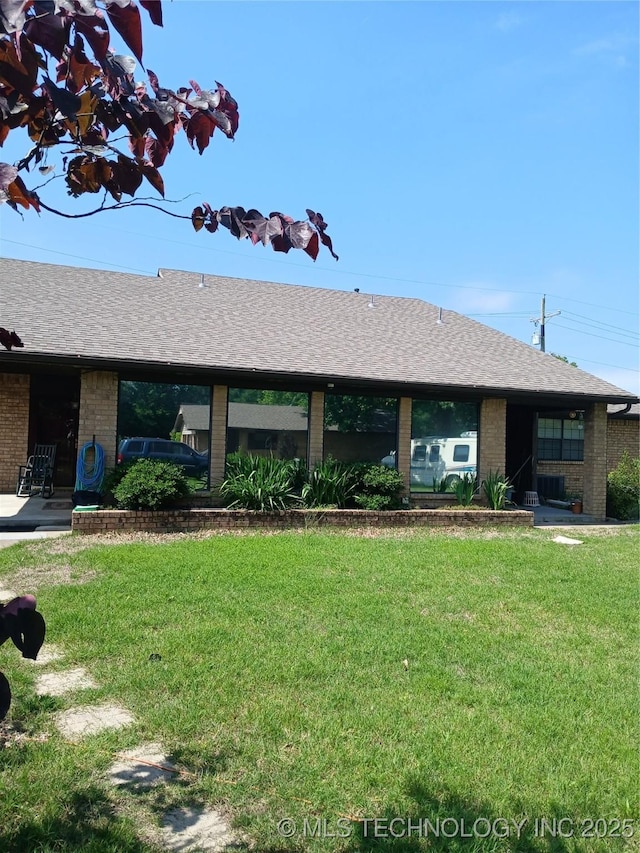 715 Kiowa, Hartshorne, OK 74547 - view of front facade featuring brick siding, a front yard, and roof with shingles