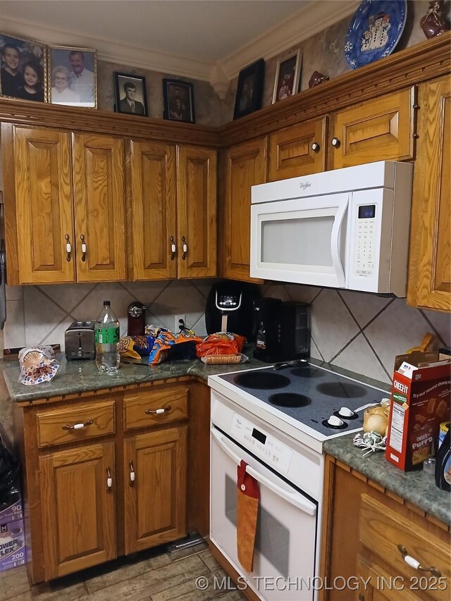 715 Kiowa, Hartshorne, OK 74547 - kitchen with white appliances, brown cabinetry, and ornamental molding