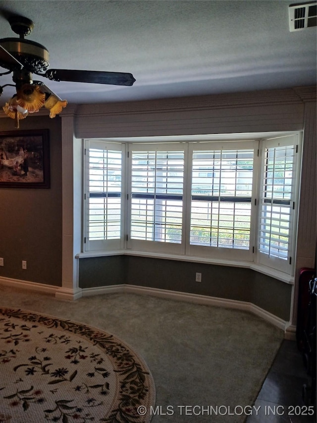 715 Kiowa, Hartshorne, OK 74547 - empty room with a ceiling fan, carpet floors, and baseboards