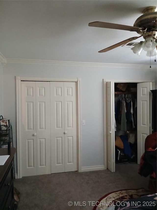 715 Kiowa, Hartshorne, OK 74547 - carpeted bedroom with ornamental molding, ceiling fan, and two closets