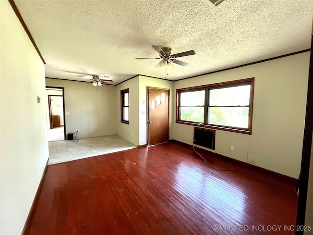 503 NE 4th St, Stigler, OK 74462 - empty room featuring wood finished floors, a textured ceiling, a ceiling fan, and crown molding