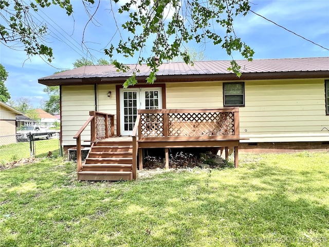 503 NE 4th St, Stigler, OK 74462 - back of property with a wooden deck, metal roof, and french doors