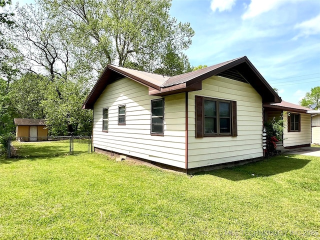 503 NE 4th St, Stigler, OK 74462 - view of home's exterior with metal roof
