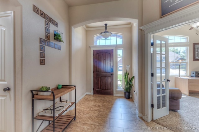 10216 N 120th E Ave, Owasso, OK 74055 - entryway with arched walkways, ornamental molding, and baseboards