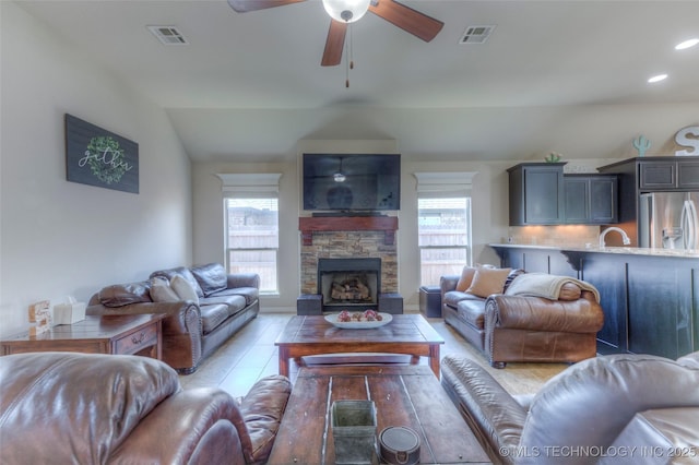 10216 N 120th E Ave, Owasso, OK 74055 - living area featuring a ceiling fan, a fireplace, and vaulted ceiling