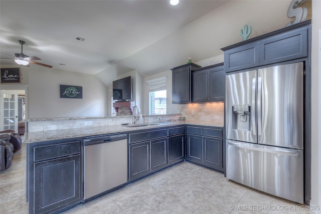 10216 N 120th E Ave, Owasso, OK 74055 - kitchen with stainless steel appliances, a sink, a peninsula, ceiling fan, and light stone counters