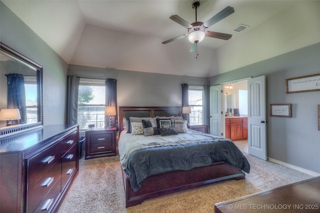 10216 N 120th E Ave, Owasso, OK 74055 - bedroom with vaulted ceiling, light colored carpet, ensuite bathroom, baseboards, and a ceiling fan