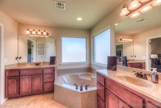 10216 N 120th E Ave, Owasso, OK 74055 - bathroom featuring two vanities and a garden tub