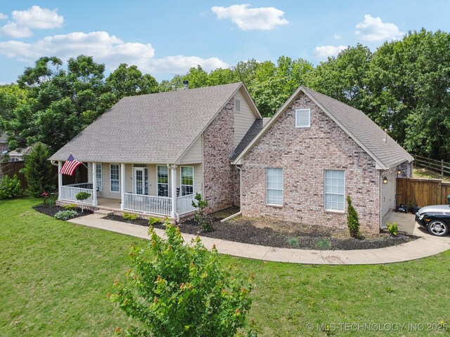 4602 S Linwood Dr, Sand Springs, OK 74063 - view of front of property featuring a porch, brick siding, and roof with shingles