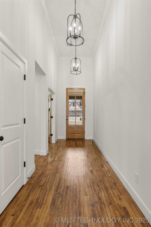 2978 E 146th St S, Bixby, OK 74008 - entryway featuring a chandelier, ornamental molding, dark wood-style flooring, and baseboards