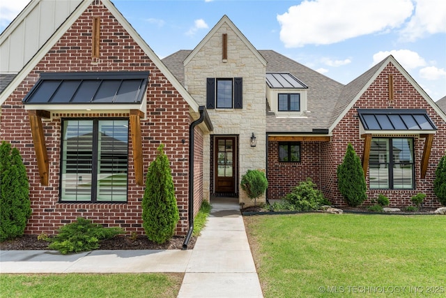 2978 E 146th St S, Bixby, OK 74008 - view of front of home featuring a front lawn, brick siding, stone siding, board and batten siding, and a shingled roof