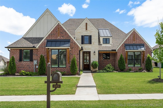 2978 E 146th St S, Bixby, OK 74008 - view of front of home with board and batten siding, a front lawn, brick siding, and a standing seam roof