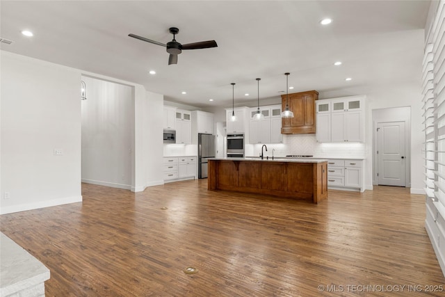 2978 E 146th St S, Bixby, OK 74008 - kitchen featuring appliances with stainless steel finishes, ceiling fan, a sink, tasteful backsplash, and open floor plan