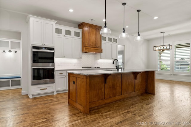 2978 E 146th St S, Bixby, OK 74008 - kitchen with double oven, a sink, tasteful backsplash, wood finished floors, and recessed lighting