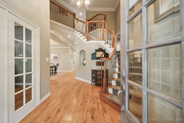 3335 E 93rd St, Tulsa, OK 74137 - foyer featuring ornamental molding, stairway, a chandelier, baseboards, and wood finished floors