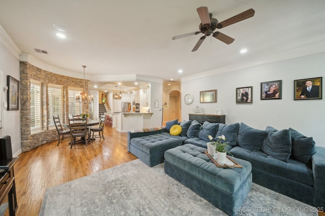 3335 E 93rd St, Tulsa, OK 74137 - living area featuring crown molding, a chandelier, arched walkways, light wood-type flooring, and ceiling fan