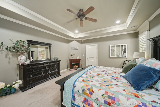 3335 E 93rd St, Tulsa, OK 74137 - bedroom with a lit fireplace, carpet, a tray ceiling, ornamental molding, and a ceiling fan