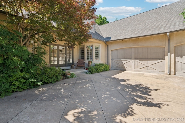 3335 E 93rd St, Tulsa, OK 74137 - view of front facade featuring concrete driveway, a garage, stucco siding, and roof with shingles