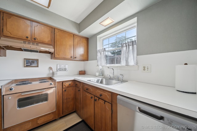 5538 E 46th St Unit 9, Tulsa, OK 74135 - kitchen featuring under cabinet range hood, electric range, stainless steel dishwasher, a sink, and light countertops