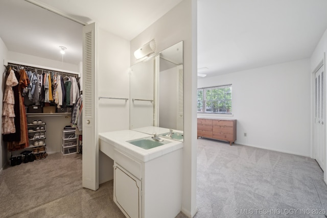 5538 E 46th St Unit 9, Tulsa, OK 74135 - full bath featuring vanity, a walk in closet, and baseboards