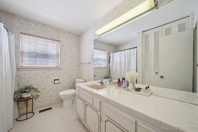 5538 E 46th St Unit 9, Tulsa, OK 74135 - full bath featuring wallpapered walls, toilet, vanity, tile patterned floors, and a closet