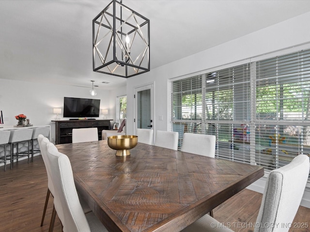 5553 S Delaware Ct, Tulsa, OK 74105 - dining space featuring wood finished floors and a chandelier