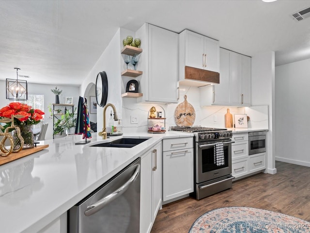 5553 S Delaware Ct, Tulsa, OK 74105 - kitchen featuring stainless steel appliances, a sink, open shelves, decorative backsplash, and white cabinets