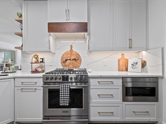 5553 S Delaware Ct, Tulsa, OK 74105 - kitchen with stainless steel range with gas stovetop, extractor fan, decorative backsplash, and white cabinetry